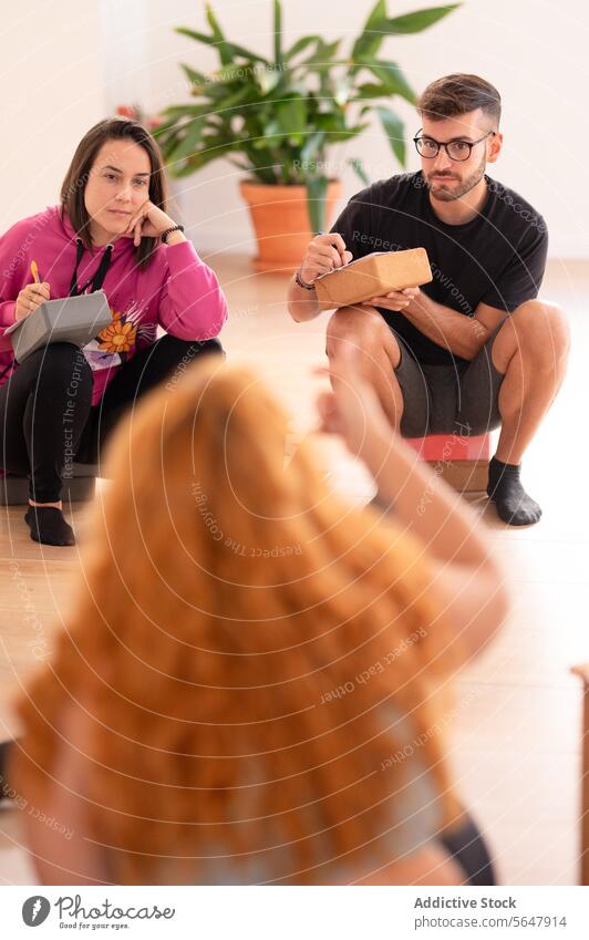 Positive group of yoga students sitting on floor in training center practitioners studio positive smile practice wellness together happy fit spirit session