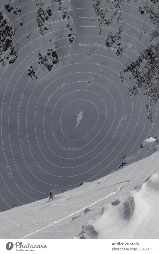 Person snowboarding on snow covered mountain slope person snowboarder snowcapped vacation winter clear sky full body anonymous majestic blue sky enjoy canada