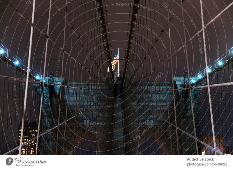 Illuminated Brooklyn Bridge with American Flag at Night, Manhattan bridge night illuminated flag landmark architecture structure city urban travel destination