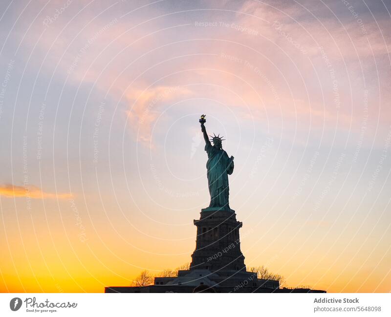 Statue of Liberty on shore under sundown sky statue statue of liberty monument landmark america usa united states river new york sunset ripple district city