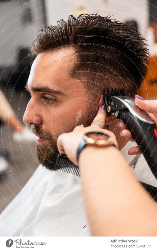 Cropped unrecognizable female hairstylist using electric trimmer on male client's hair at salon Hairdresser Trimmer Man Salon Care Service Hand Client Process