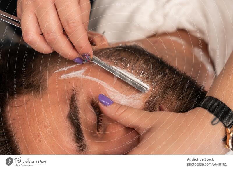 From above crop unrecognizable hands of female barber shaving male client's beard with straight razor at salon Hairdresser Shave Straight Razor Beard Man Salon