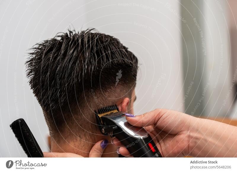 Cropped unrecognizable female hairstylist using electric trimmer on male client's hair at salon Hairdresser Trimmer Man Salon Care Service Hand Client Process