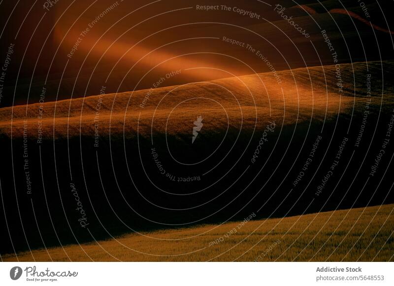 Enigmatic light rays over rolling hills at dusk landscape golden glow ethereal beauty nature darkness undulating field serene tranquil rural outdoor scenic