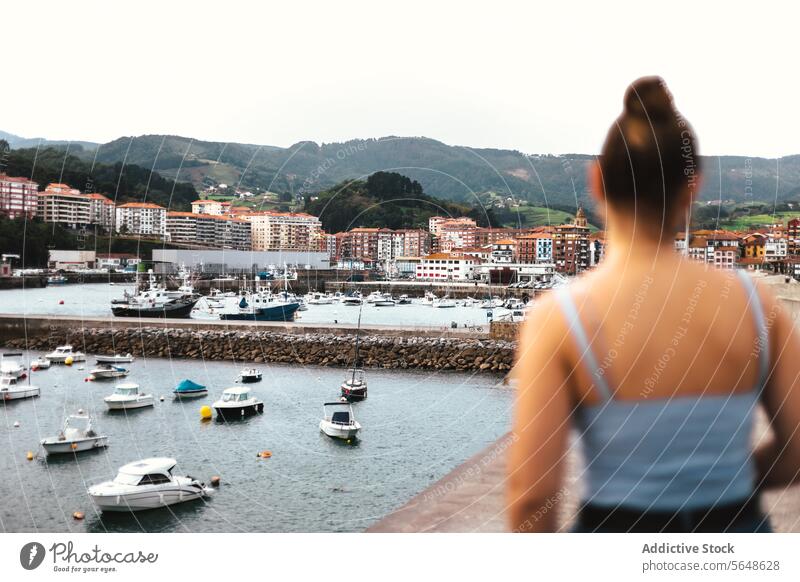 Blur woman admiring view of sea river town embankment water admire waterfront trip tourism boat casual shore coast anonymous blur relax street daytime idyllic