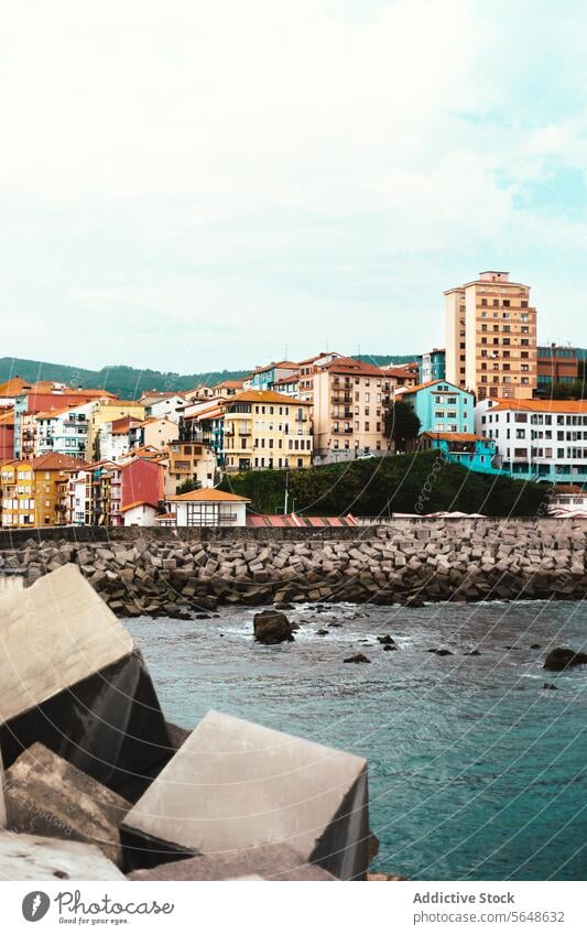 Cityscape with buildings near river in city cityscape stone water residential ripple house picturesque construction facade shore river bank coast structure