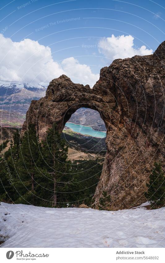 Scenic Rock Arch Overlooking Mountain Lake in Pyrenees arch rock mountain lake turquoise pyrenees ordesa national park monte perdido torla huesca scenic view