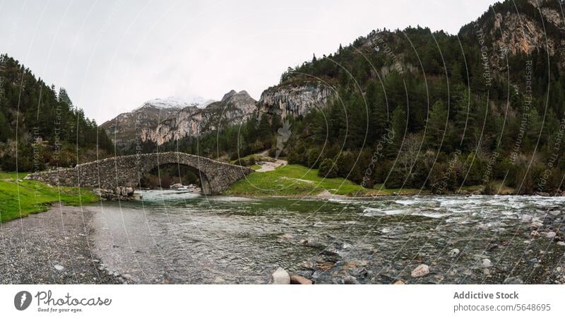 Scenic view of Torla-Ordesa with historic bridge torla ordesa pyrenees huesca national park monte perdido river landscape panoramic stone ancient arch scenic