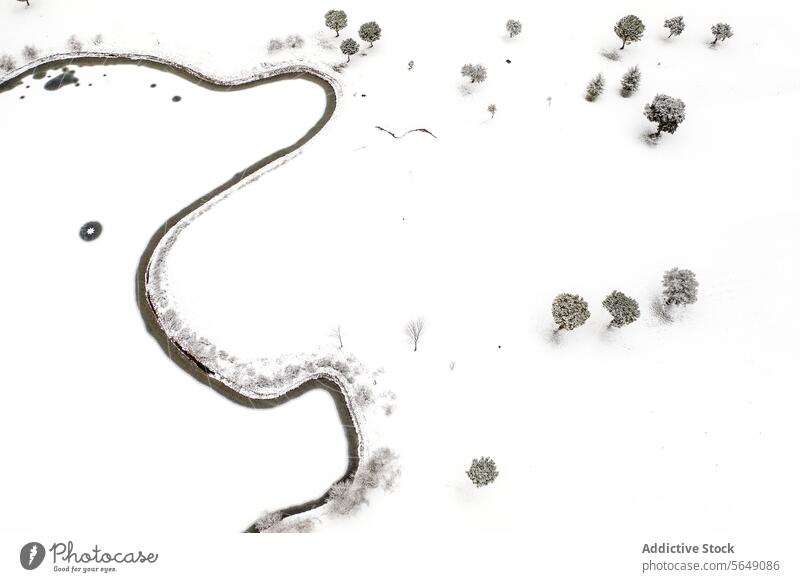 Winding River Through Snowy Landscape in Guadalajara aerial view river snow landscape guadalajara spain meandering serene covered sparse trees bushes white