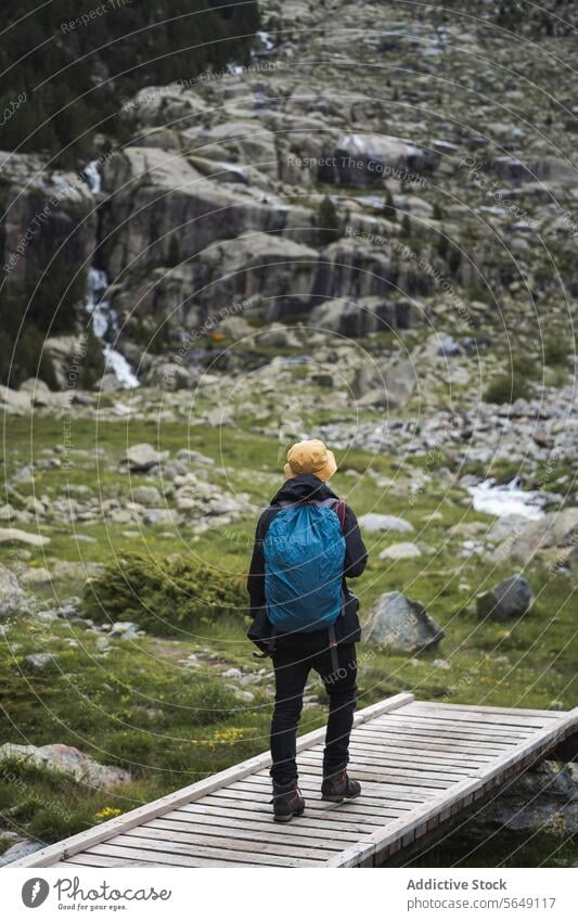 Anonymous backpacker walking towards rocky mountain Man Backpacker Hike Mountain Footbridge Nature Walk Adventure Rocky Vacation National Park Bridge Traveler