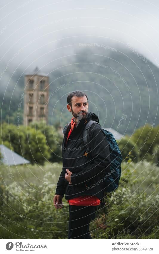 Man with backpack looking away while hiking in countryside Hike Backpack Adventure Nature Mountain Hiker Travel Vacation Thoughtful Traveler Trekking Backpacker