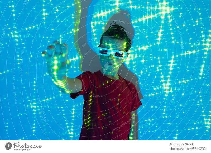 Adorable kid wearing 3D glasses in neon studio with blue lights Boy Glasses Glow Neon Light Entertain Carefree Futuristic Illuminate Childhood Cute Kid