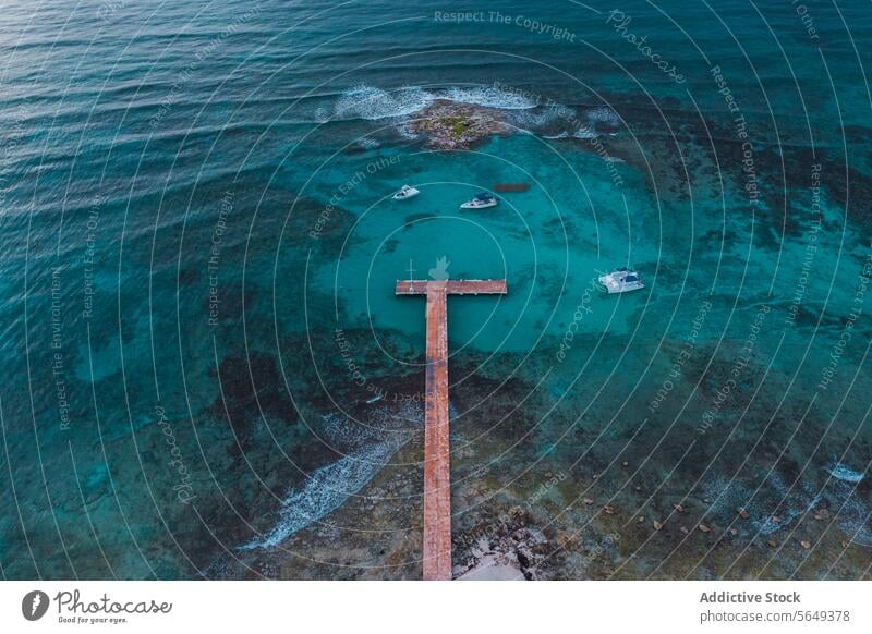 Serene Pier Overlooking Cancun Reef aerial view wooden pier blue water coral reef tranquil serene ocean sea nature landscape travel tropical paradise Mexico