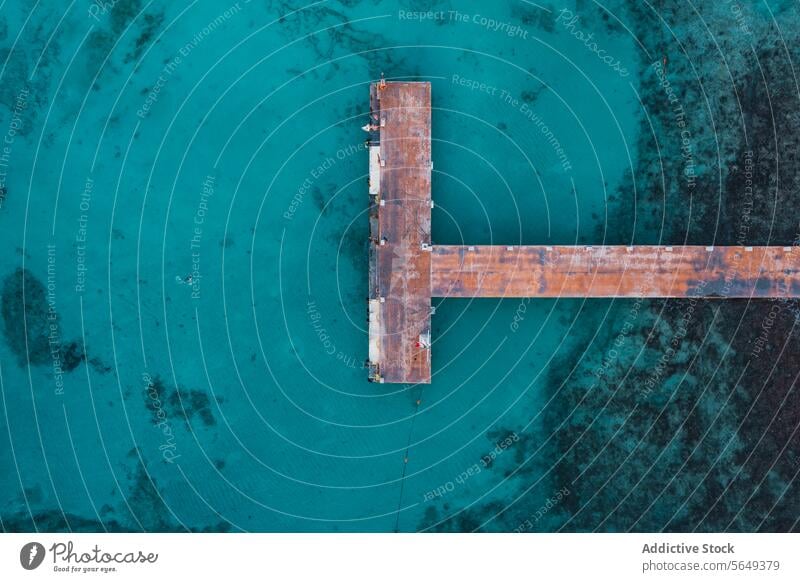 Aerial View of T-Shaped Pier in Cancun aerial view T-shaped pier old wooden crystal-clear turquoise waters Mexico ocean sea nature landscape travel tropical