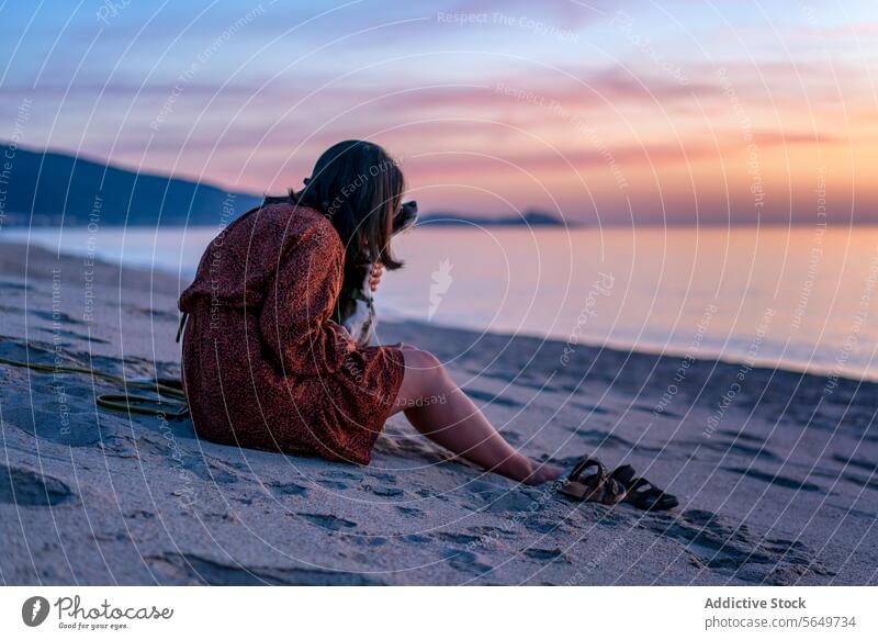 Anonymous woman with dog spending leisure time at beach tourist anonymous ocean serene vacation sunset sky side view sand friendship beautiful sea water nature