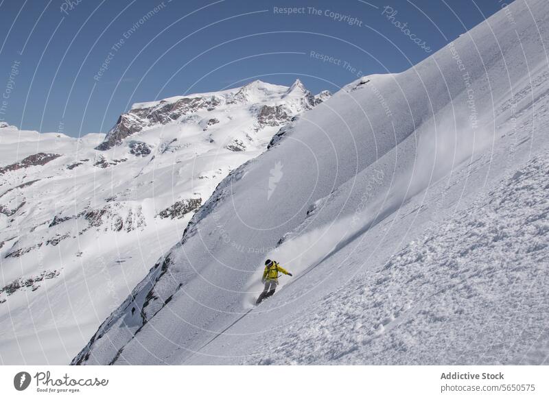 Unrecognizable Snowboarder in action enjoying vacation on snowy mountain in Zermatt under blue sky Tourist Sport Mountain Slope Vacation Action Adventure