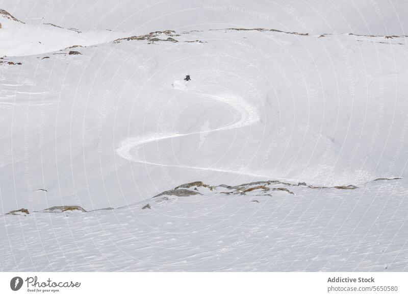 From above of Anonymous Tourist in ski suit skiing down on mountain slope during vacation at Swiss Alps Skier Slope Snow Mountain Adventure Courage Motion Sport