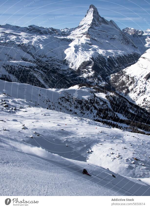 High angle of Unrecognizable Snowboarder in action enjoying vacation on snowy mountain slope in Zermatt Tourist Sport Mountain Slope Vacation Action Adventure