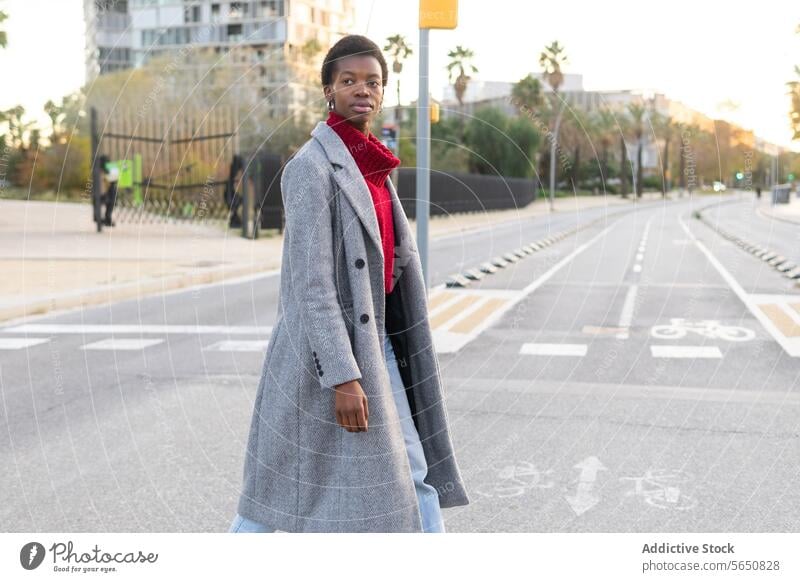 Confident black woman crossing road in city crosswalk roadway street downtown urban pedestrian confident charismatic respectable serious self assured female