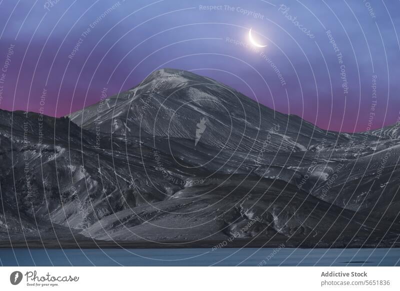 Twilight over Icelandic mountain with crescent moon twilight iceland serene landscape sky dusk nature outdoor volcanic terrain tranquil majestic beauty scenic