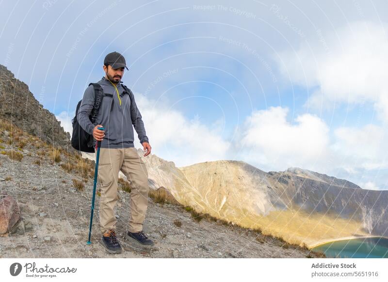 Hiker exploring the scenic Nevado de Toluca in Mexico hiker nevado de toluca mexico trekking walking stick mountain lake outdoors adventure landscape nature sky