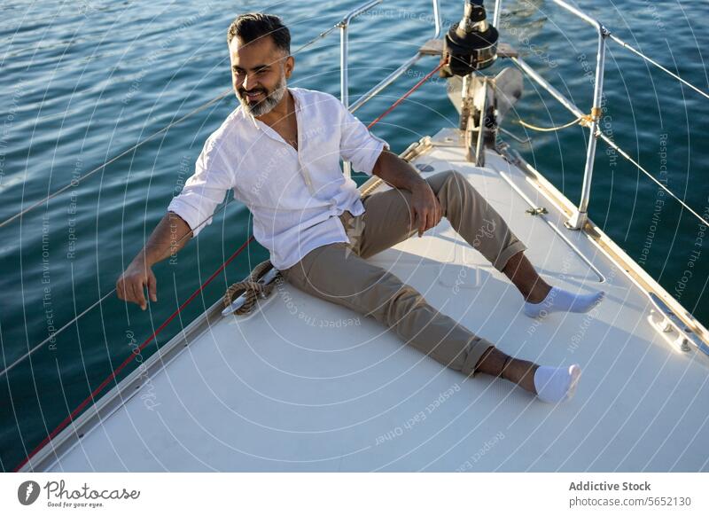 Man sitting on yacht in ocean water man sea float traveler trip boat vessel enjoy ripple marine vacation happy tourism glad tourist leisure aqua optimist