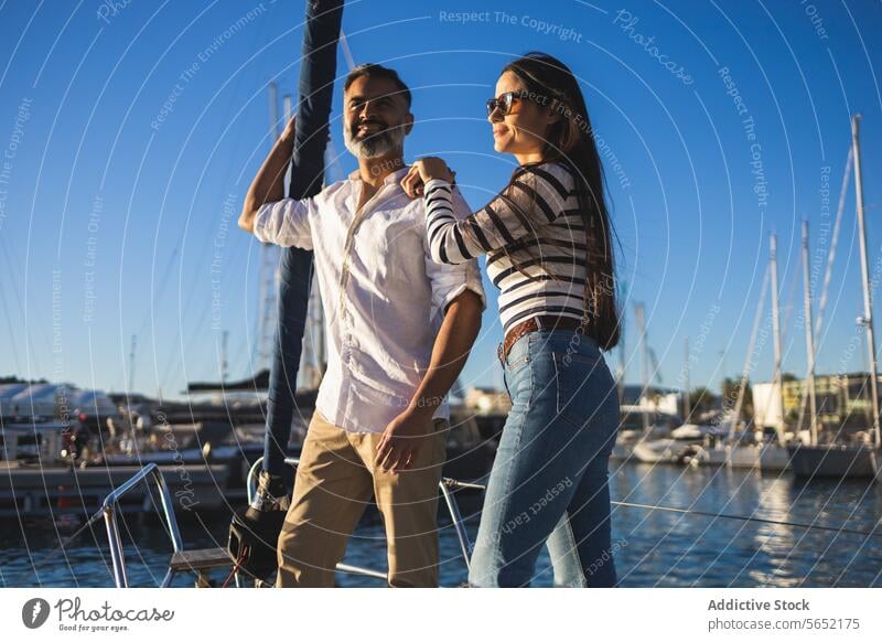 Happy couple standing on seafront trip travel yacht romantic love enjoy happy tourism modern boat positive journey coast smile marine water girlfriend shore