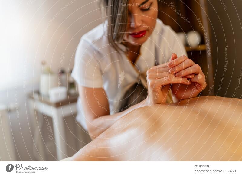 Therapist doing hand massage on a client's back at a spa. beauty salon Wellness Hotel Concept image pressure point back massage hands relaxation wellness