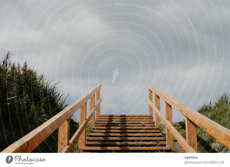 View from bottom to top at the end of a staircase in the countryside in St. Peter-Ording Central perspective Stairs view from bottom to top End of a staircase