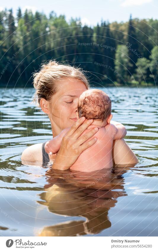 Mother swims with her baby girl in a summer lake Acclimatization Young Adult acclimation alfresco alternative bath bathe bathing camping child cold hardening