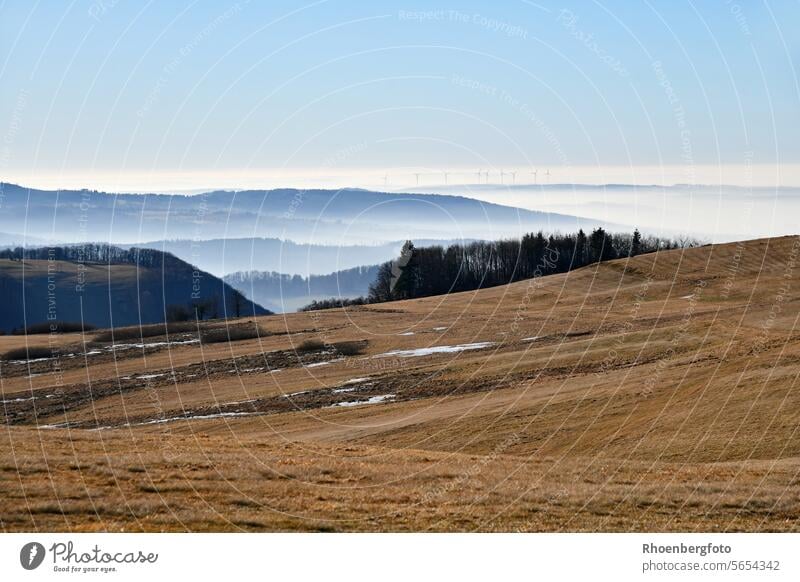 Hike on the Wasserkuppe on a beautiful day in January. You can see the wind turbines in the distance above the fog. Hesse hessian rhön Rhön mountain Glider