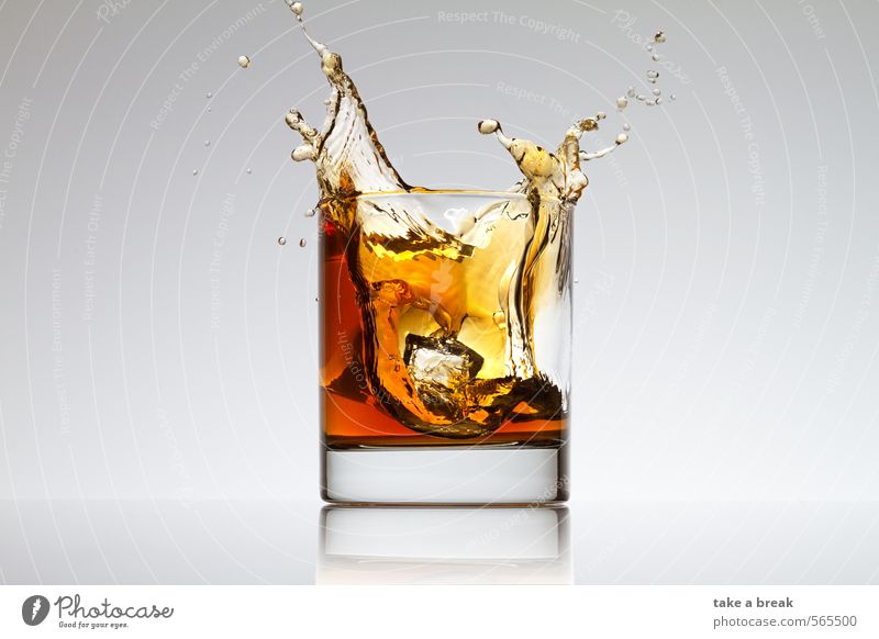 Splashes in glass Food Beverage Cold drink Hot drink Lemonade Juice Tea Alcoholic drinks Spirits Glass Water Brown Yellow Orange Colour photo Studio shot