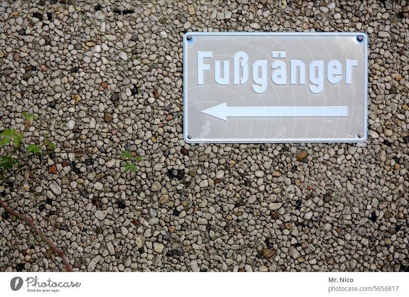 pedestrian Signs and labeling Signage Road marking Pedestrian Lanes & trails Arrow to the left groundbreaking Wall (building) Stone facade Direction Orientation