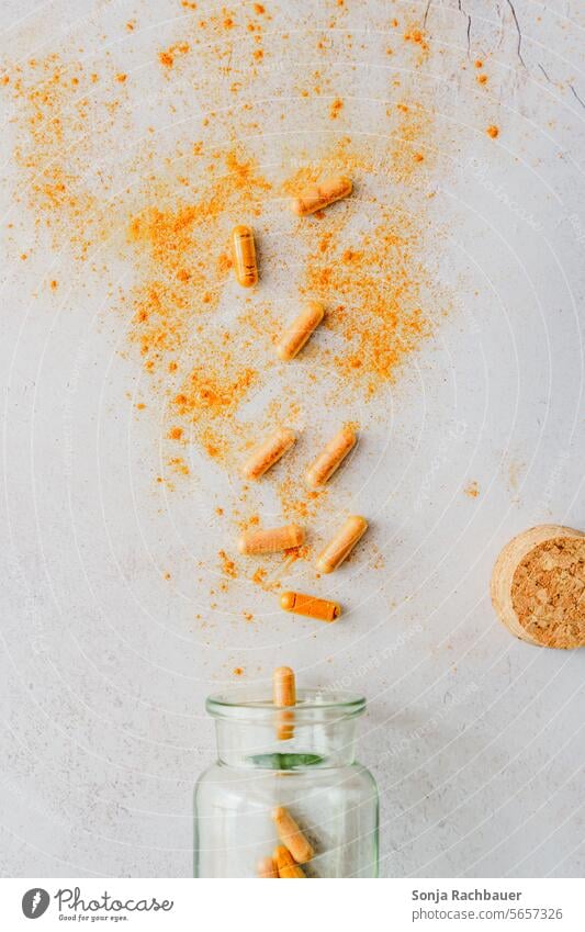 Turmeric capsules scattered on a table turmeric Capsule Glass medicine Healthy Medication Painkiller Pharmacy Illness Pill antibiotic dose background Addiction