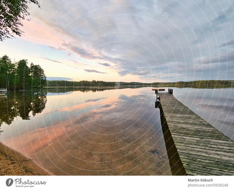 Wooden jetty jutting into a Swedish lake. Nature shot from the Scandinavian bathing evening beautiful dusk fog travel calm landscape horizon photo evening mood