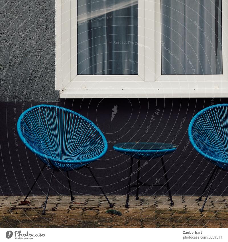 Two blue wicker chairs stand sadly in a courtyard, with windows behind them Cane chair Blue Courtyard Window wickerwork Graphic Appealing set Sit Sit down Chair