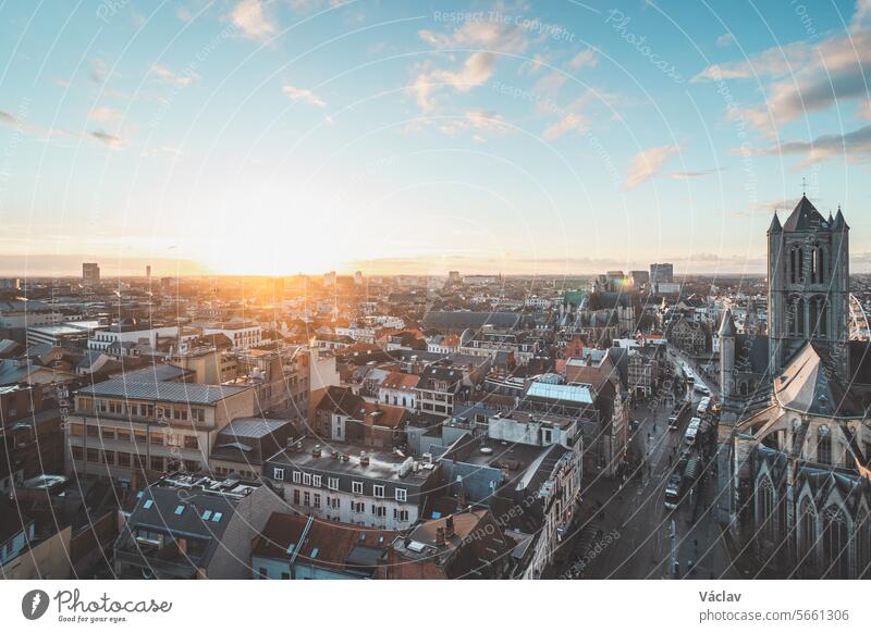 Watching the sunset over Ghent from the historic tower in the city centre. Romantic colours in the sky. Red light illuminating Ghent, Falnders region, Belgium