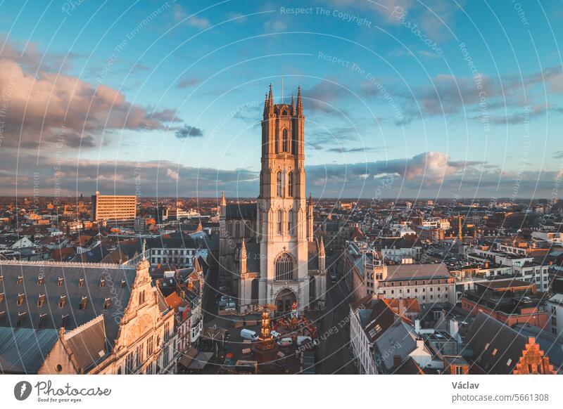 Watching the sunset over Ghent from the historic tower in the city centre. Romantic colours in the sky. Red light illuminating Ghent, Falnders region, Belgium