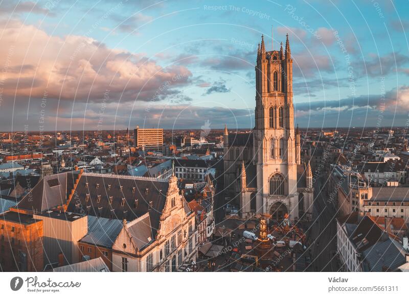 Watching the sunset over Ghent from the historic tower in the city centre. Romantic colours in the sky. Red light illuminating Ghent, Falnders region, Belgium