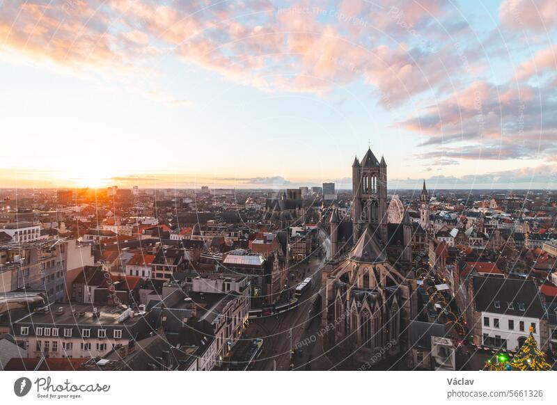 Watching the sunset over Ghent from the historic tower in the city centre. Romantic colours in the sky. Red light illuminating Ghent, Falnders region, Belgium