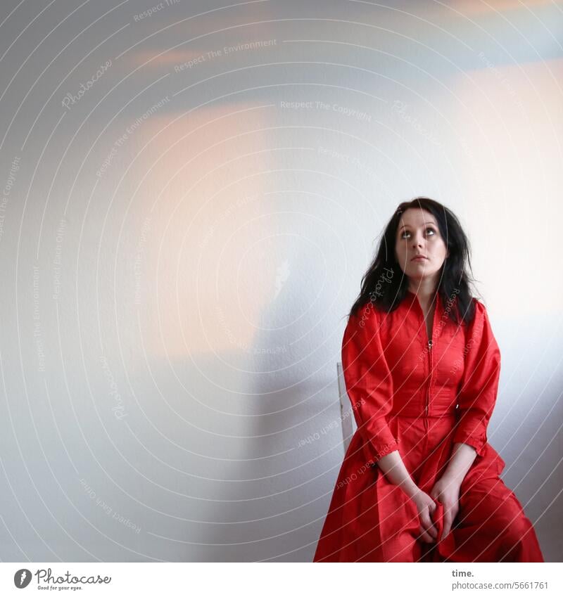 seated woman in red dress Woman Dress Red Sit Room Upward Long-haired Dark-haired Meditative Expectation feminine Feminine portrait Skeptical Observe look