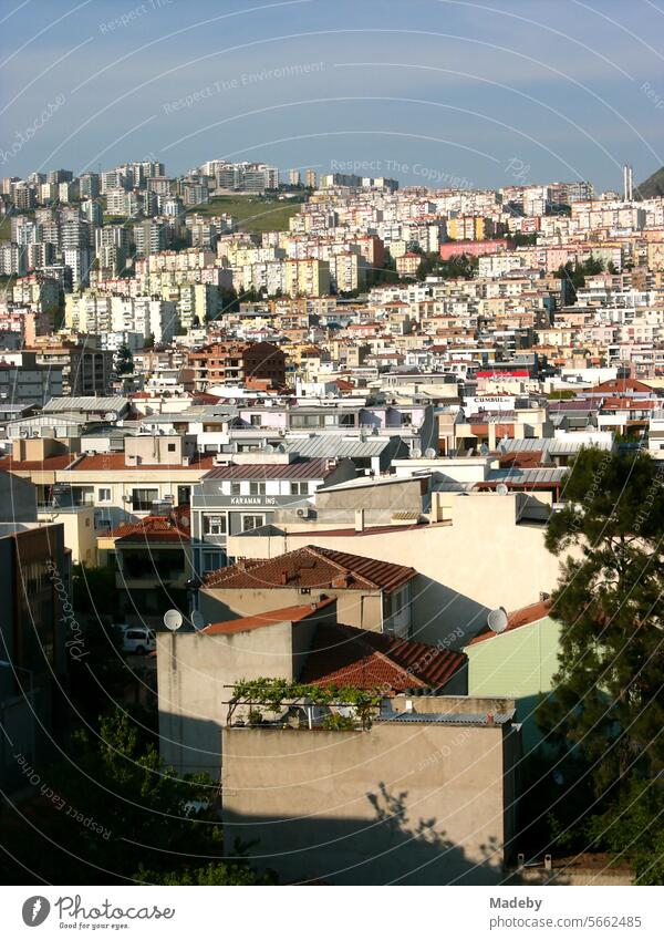 Hillside with modern apartment buildings and skyscrapers in the light of the setting sun in summer in Cigli district of Izmir on the Aegean Sea in Turkey