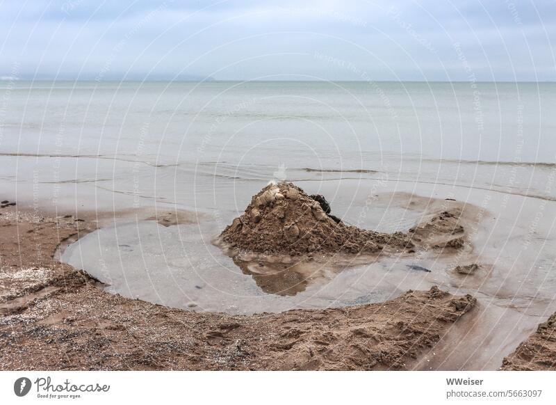 An empty beach in cloudy weather in the fall with traces of previous visitors Beach Sand Ocean Adriatic Sea Mediterranean sea Italy marina Ravenna Lake