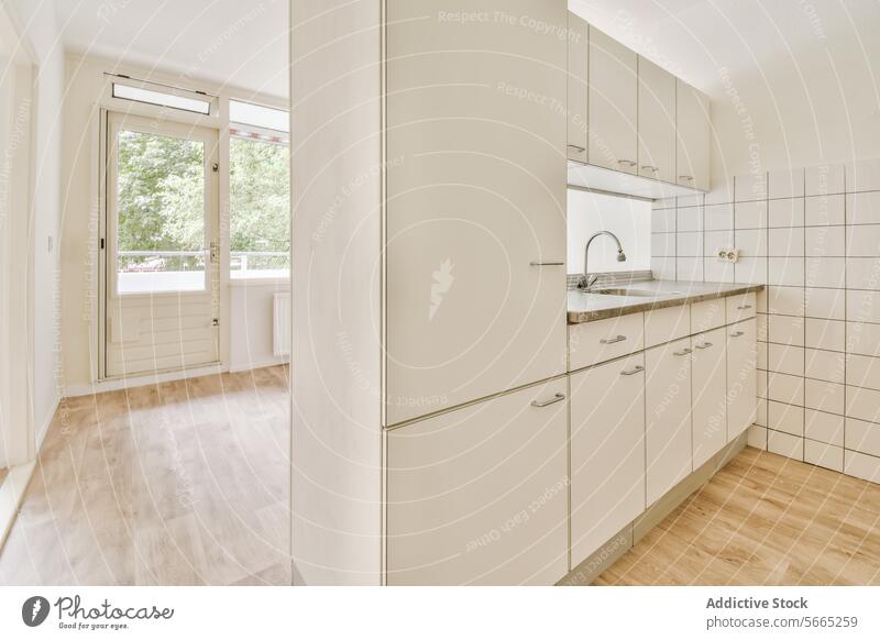 Bright and modern kitchen interior with white cabinetry contemporary tile backsplash wooden flooring bright light natural space home house design decor