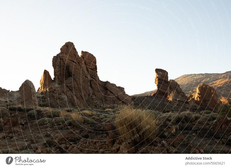 Majestic rock formations under the sunset light golden towering landscape natural scene rugged geology geologic nature outdoors travel destination tourism