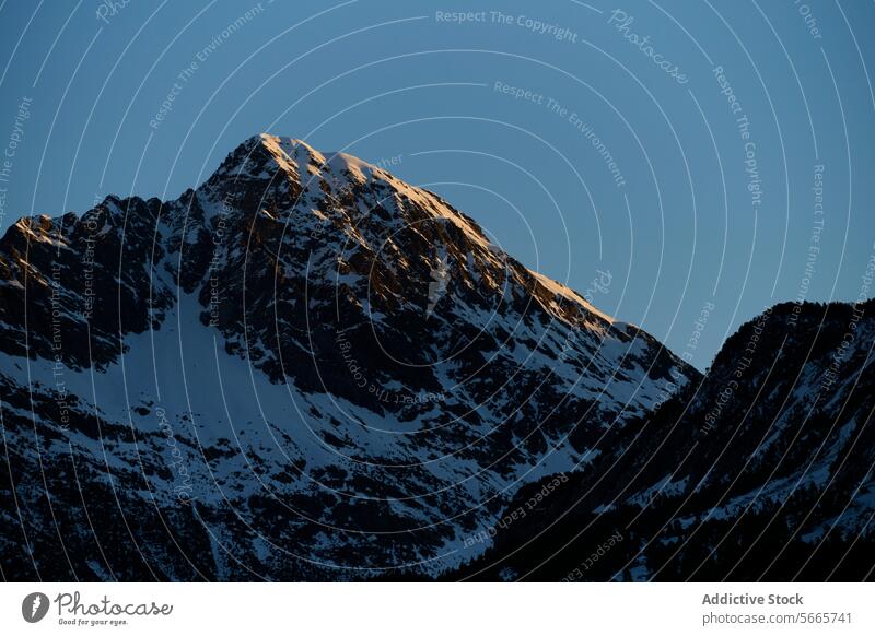 A serene dawn in the Pyrenees with the sun kissing the peak of Ibon de Gorgutes, near Benasque in Huesca, Spain Mountain Dawn Sunlight Peak Rugged Texture