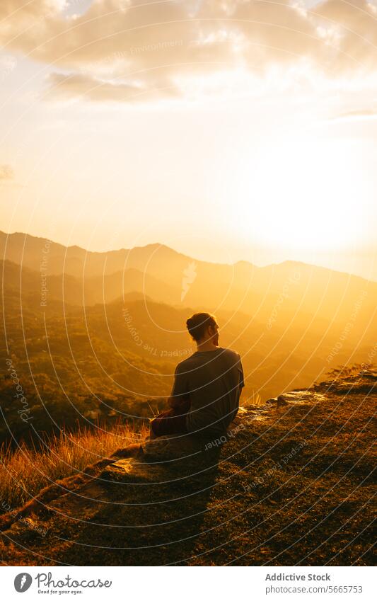 Serene mountain sunset with solitary figure in Minca, Colombia person serene peaceful landscape scenic warm light edge overlooking solitude tranquility nature