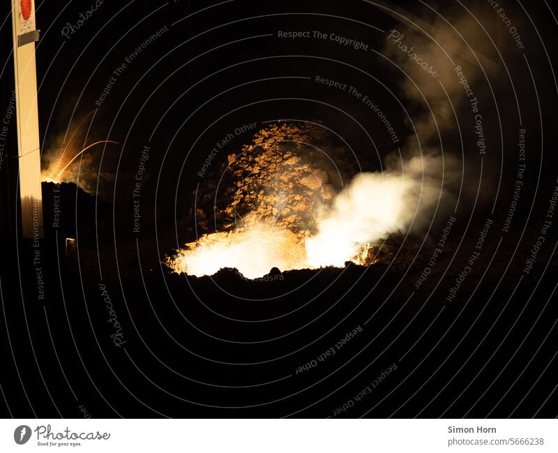 Holes in the ground that smoke, fume and burn Explosion Smoke Fire Earth Spark Energy Hot Night Pyrotechnics Firecracker Effects Light New Year's Eve