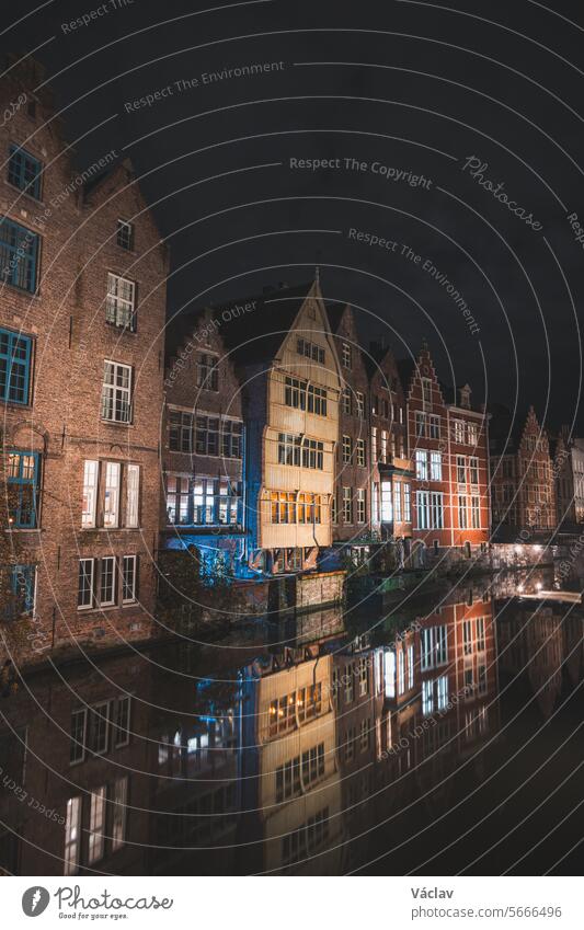 View of classic medieval houses reflected in a water canal in the centre of Ghent, Flanders region, Belgium. Colourful facades of the houses of rich citizens