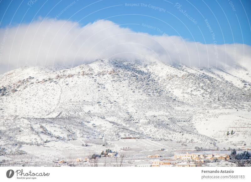 Snow. Winter landscape covered in a white blanket of snow covering mountains and roads. Trees with snow. Clear day. White blanket due to a storm with heavy snowfall. In Spain. January. 2024.